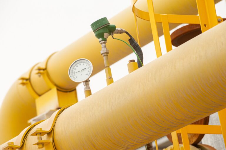 Pressure gauge on gas compressor equipment illustrating industrial maintenance and safety practices.