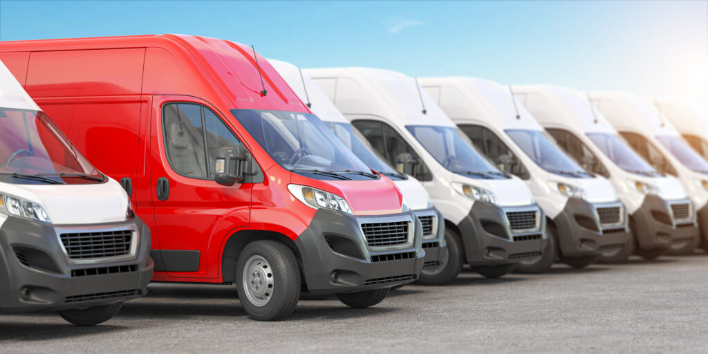 Row of delivery vans, red van among white fleet vehicles, fleet management optimization.