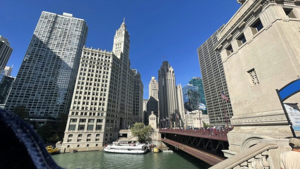 a river with a bridge and tall buildings