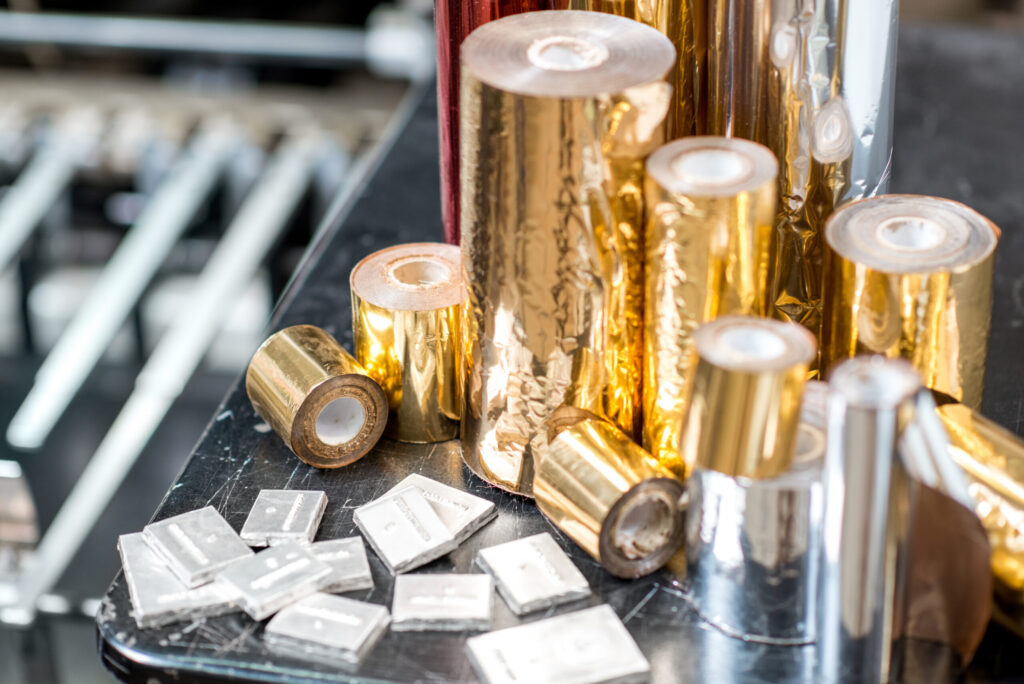 Foil rolls and sealing squares for foil sealer machines and product packaging.