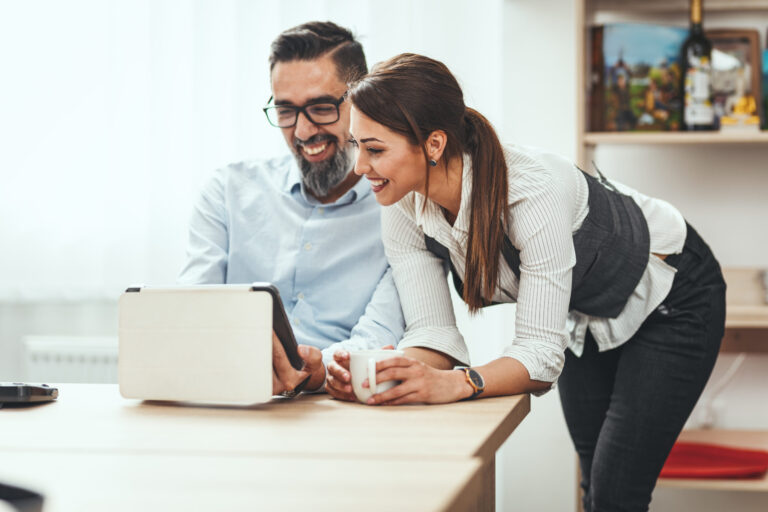 Man and woman looking at tablet device, lifestyle and technology content