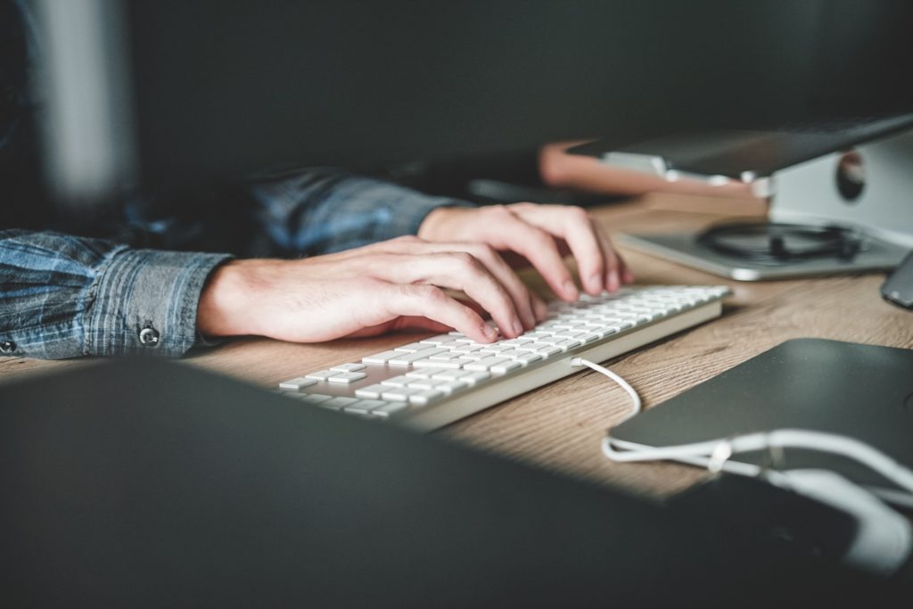 a person's hands on a keyboard