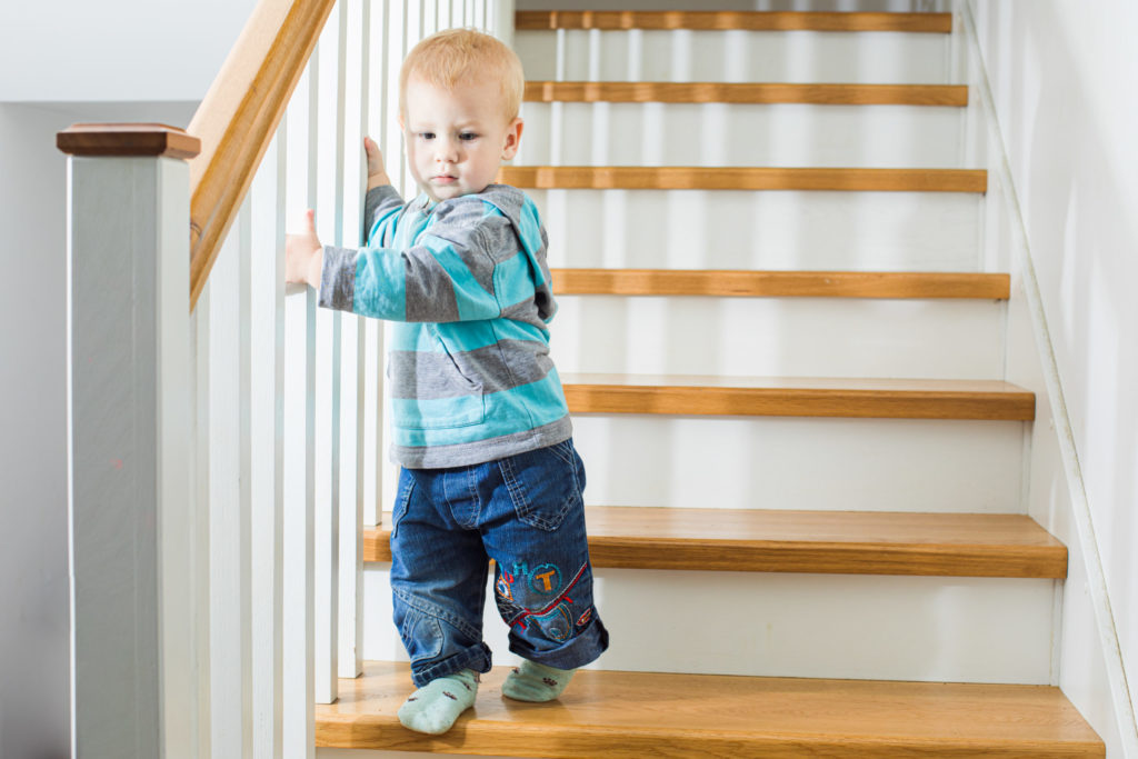 a young boy climbing up a set of stairs