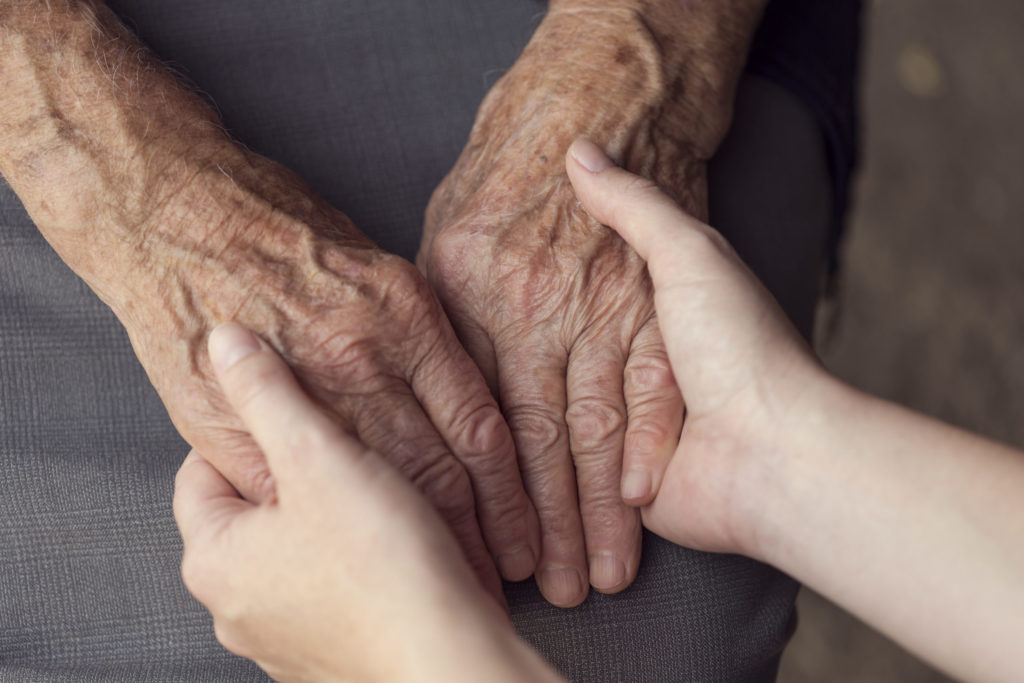 a person's hands on a couch