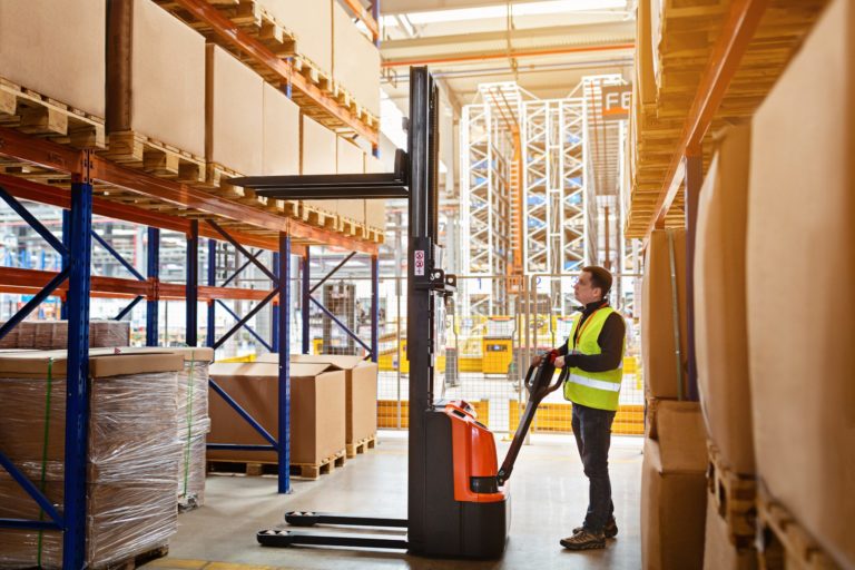 WORKER WITH A REACH TRUCK