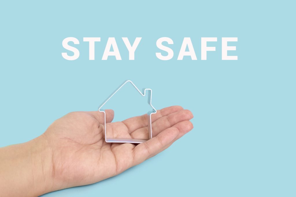 STAY SAFE with house on blue background