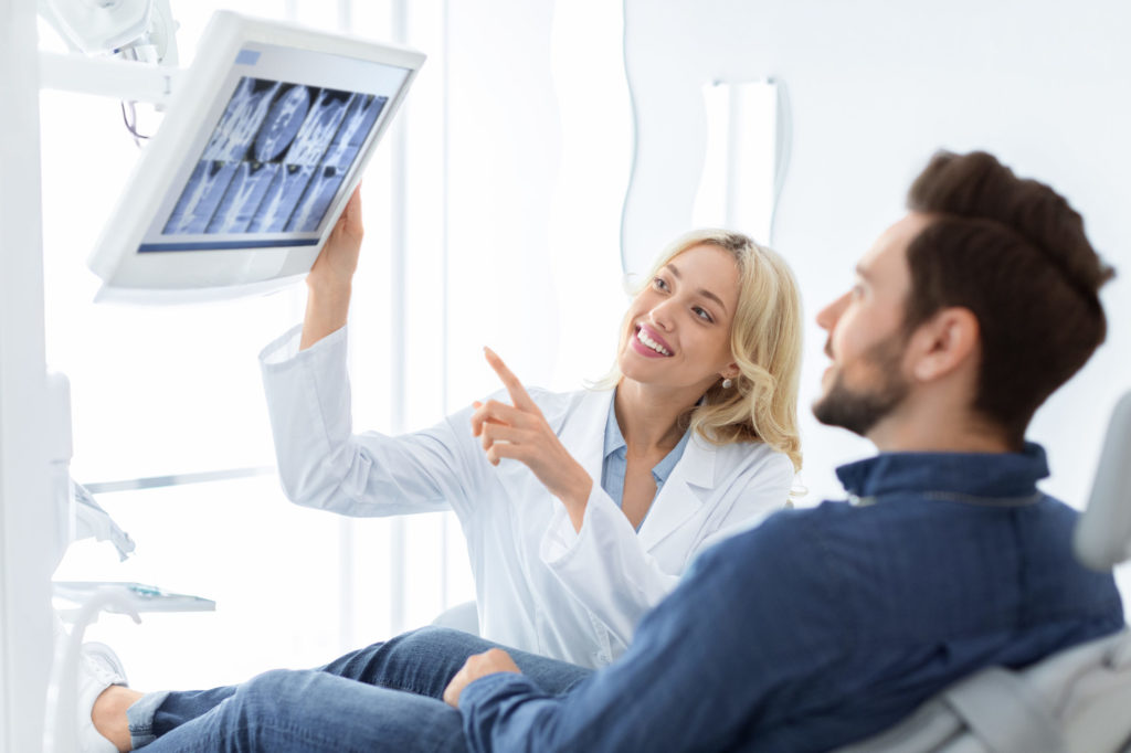 a man and a woman looking at a paper