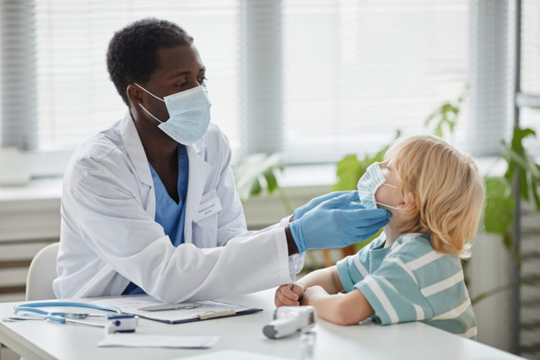 African American Doctor Examining Little Boy